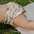 Load image into Gallery viewer, Baby wearing a Reusable Cloth Nappy – Palm Garden | 2.0 | My Little Gumnut shown outdoors to demonstrate comfort and flexibility.