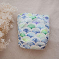 Load image into Gallery viewer, Reusable Cloth Nappy – Mermaid | 2.0 | My Little Gumnut folded flat to highlight the ocean-inspired design detail.