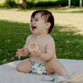 Load image into Gallery viewer, Baby wearing a Reusable Cloth Nappy – Mermaid | 2.0 | My Little Gumnut shown outdoors to demonstrate comfort and flexibility.