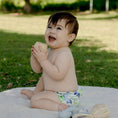 Load image into Gallery viewer, Baby wearing a Reusable Cloth Nappy – Mermaid | 2.0 | My Little Gumnut shown outdoors for a lifestyle fit image.