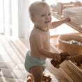 Load image into Gallery viewer, Baby wearing a Reusable Cloth Nappy – Mint | 2.0 | My Little Gumnut shown during everyday play for a lifestyle fit image.