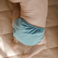 Load image into Gallery viewer, Baby wearing a Reusable Cloth Nappy – Blue | 2.0 | My Little Gumnut with a secure fit and soft bamboo lining.