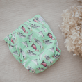 Load image into Gallery viewer, Reusable Cloth Nappy – Cockatoo | 2.0 | My Little Gumnut folded flat to highlight the Australian bird print detail.