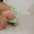 Load image into Gallery viewer, Baby wearing a Reusable Cloth Nappy – Cockatoo | 2.0 | My Little Gumnut shown from the side to demonstrate fit and comfort.