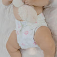 Load image into Gallery viewer, Baby wearing a Reusable Cloth Nappy – Flowers | 2.0 | My Little Gumnut with a secure fit and soft bamboo lining.
