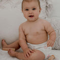 Load image into Gallery viewer, Baby wearing a Reusable Cloth Nappy – Flowers | 2.0 | My Little Gumnut shown to demonstrate fit and comfort.