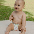 Load image into Gallery viewer, Baby wearing a Reusable Cloth Nappy – Pineapples | 2.0 | My Little Gumnut shown during outdoor play to demonstrate everyday comfort.
