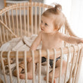 Load image into Gallery viewer, Baby wearing a Reusable Cloth Nappy – Grey | 2.0 | My Little Gumnut shown in a cot to demonstrate comfort and everyday use.