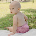Load image into Gallery viewer, Baby wearing a Reusable Cloth Nappy – Monstera Pink | 2.0 | My Little Gumnut, designed for comfort and everyday movement.