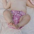 Load image into Gallery viewer, Baby wearing a Reusable Cloth Nappy – Monstera Pink | 2.0 | My Little Gumnut with a secure fit and soft bamboo lining.