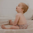 Load image into Gallery viewer, Baby wearing a Reusable Cloth Nappy – Plaid | 2.0 | My Little Gumnut shown during everyday play to demonstrate flexibility and fit.