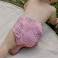 Load image into Gallery viewer, Baby wearing a Reusable Cloth Nappy – Monstera Pink | 2.0 | My Little Gumnut shown lying down to demonstrate comfort and flexibility.