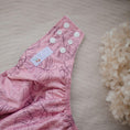 Load image into Gallery viewer, Reusable Cloth Nappy – Monstera Pink | 2.0 | My Little Gumnut folded flat to showcase the pink botanical print and adjustable fit.