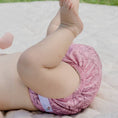 Load image into Gallery viewer, Baby wearing a Reusable Cloth Nappy – Monstera Pink | 2.0 | My Little Gumnut shown from behind to demonstrate fit and comfort.