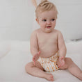 Load image into Gallery viewer, Baby wearing a Reusable Cloth Nappy – Sandy Blaze | 2.0 | My Little Gumnut shown sitting to demonstrate fit and comfort.