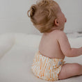 Load image into Gallery viewer, Baby wearing a Reusable Cloth Nappy – Sandy Blaze | 2.0 | My Little Gumnut shown from behind to demonstrate secure fit and flexibility.