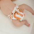 Load image into Gallery viewer, Reusable Newborn Cloth Nappy in a neutral design on a baby, showcasing the Archie style from My Little Gumnut.