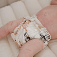 Load image into Gallery viewer, Reusable Newborn Cloth Nappy in Palm Garden design on a baby, showcasing a soft, botanical theme.
