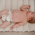 Load image into Gallery viewer, Reusable Newborn Cloth Nappy on a sleeping baby, showcasing the Palm Garden design by My Little Gumnut.