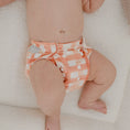 Load image into Gallery viewer, Reusable Newborn Cloth Nappy in gingham (rust) design on a baby, soft fabric and eco-friendly choice.