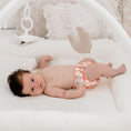 Load image into Gallery viewer, Baby lying on a play mat wearing a Reusable Newborn Cloth Nappy in Gingham (Rust) design.