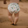 Load image into Gallery viewer, Reusable Swim Nappy on a baby's bottom, perfect for beach days and pool play, designed for comfort and convenience.