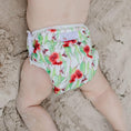 Load image into Gallery viewer, Reusable Swim Nappy - Flowering Gum on a baby playing on the sand, perfect for beach days and pool play.