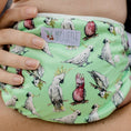 Load image into Gallery viewer, Reusable Swim Nappy featuring a vibrant cockatoo design, perfect for beach days and pool play with kids.