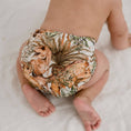 Load image into Gallery viewer, Baby wearing a Reusable Cloth Nappy – Dino Land | 2.0 | My Little Gumnut, designed for comfort and everyday movement.