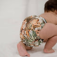 Load image into Gallery viewer, Baby wearing a Reusable Cloth Nappy – Dino Land | 2.0 | My Little Gumnut shown from behind to demonstrate fit and comfort.