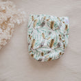 Load image into Gallery viewer, Reusable Cloth Nappy – Banksia | 2.0 | My Little Gumnut folded flat to highlight the botanical print and absorbent design.