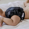Load image into Gallery viewer, Reusable cloth nappy in our Black Flora print with double gussets, adjustable sizing and soft bamboo lining for everyday comfort and leak protection.