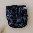 Load image into Gallery viewer, Reusable Cloth Nappy – Black Flora | 2.0 | My Little Gumnut folded flat to display the bold floral print detail.