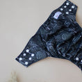 Load image into Gallery viewer, Reusable Cloth Nappy – Black Flora | 2.0 | My Little Gumnut folded flat to showcase the dark floral print and adjustable fit.