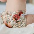 Load image into Gallery viewer, Baby wearing a Reusable Cloth Nappy – Blush Botanical | 2.0 | My Little Gumnut, designed for comfort and everyday movement.