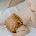 Load image into Gallery viewer, Baby wearing a Reusable Cloth Nappy – Gumnut Tan | 2.0 | My Little Gumnut, designed for comfort and everyday movement.