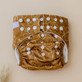 Load image into Gallery viewer, Reusable Cloth Nappy – Gumnut Tan | 2.0 | My Little Gumnut displayed flat to showcase the tan Australian-inspired print and adjustable snaps.