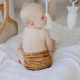 Load image into Gallery viewer, Baby wearing a Reusable Cloth Nappy – Gumnut Tan | 2.0 | My Little Gumnut shown from behind to demonstrate fit and comfort.
