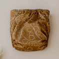 Load image into Gallery viewer, Reusable Cloth Nappy – Gumnut Tan | 2.0 | My Little Gumnut folded flat to highlight the warm neutral print detail.