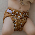 Load image into Gallery viewer, Baby wearing a Reusable Cloth Nappy – Gumnut Tan | 2.0 | My Little Gumnut with a secure fit and soft bamboo lining.