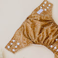 Load image into Gallery viewer, Reusable Cloth Nappy – Gumnut Tan | 2.0 | My Little Gumnut folded flat to showcase the tan print and adjustable fit.