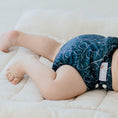 Load image into Gallery viewer, Baby wearing a Reusable Cloth Nappy – Gumnut Teal | 2.0 | My Little Gumnut with a secure fit and soft bamboo lining.