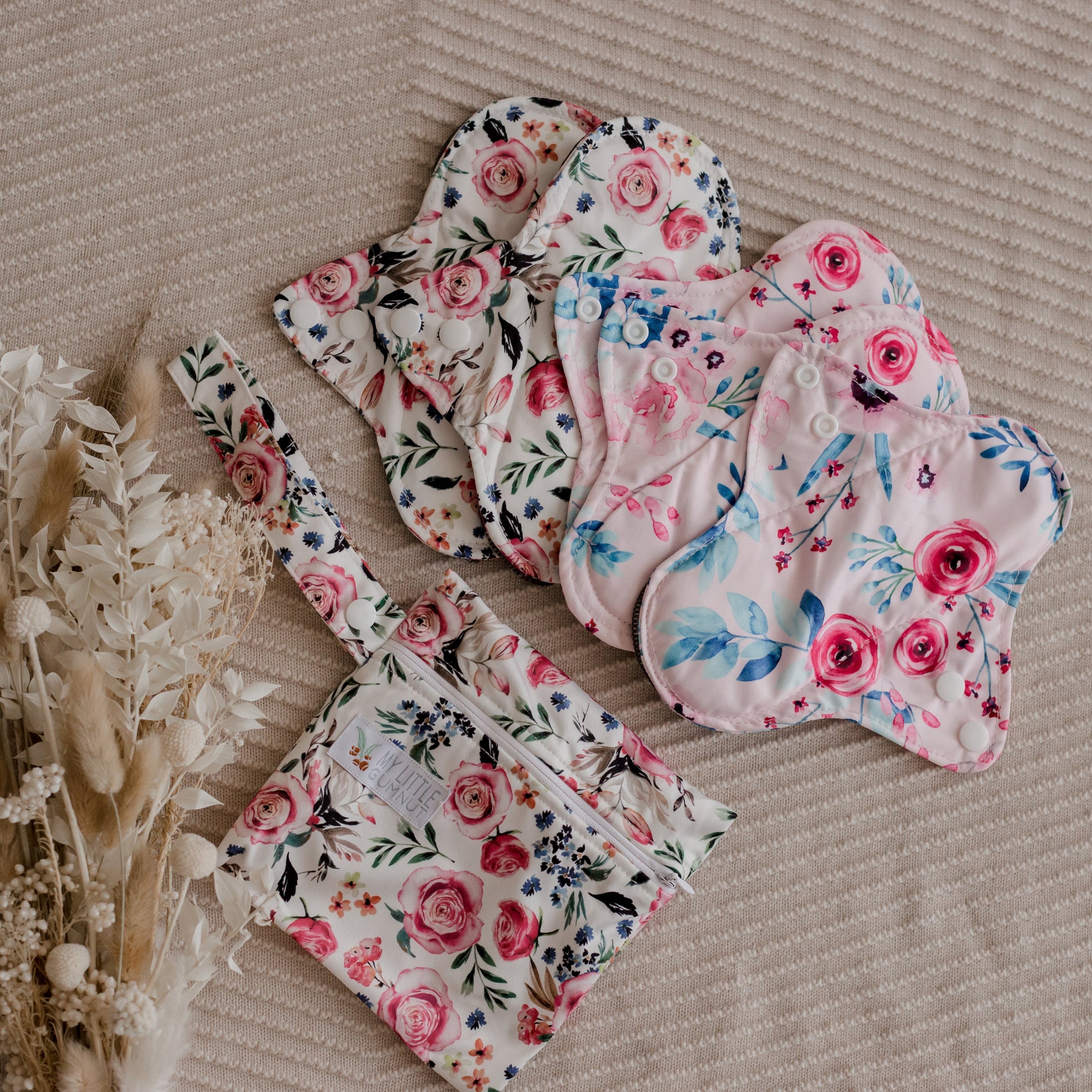 Reusable menstrual pads by my little gumnut. cloth menstrual pads. period pads. stack of menstrual pads. floral pads