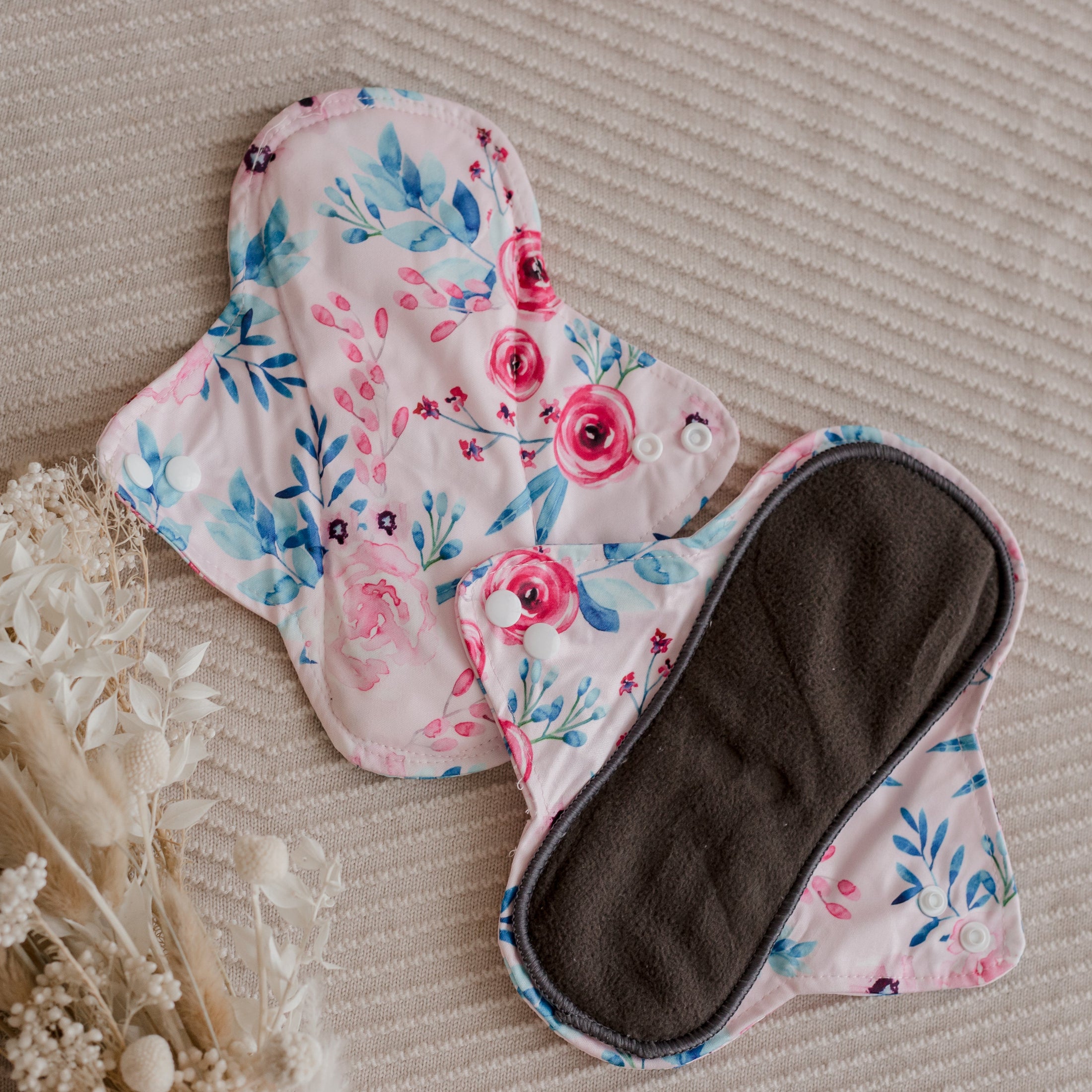 Reusable menstrual pads by my little gumnut. cloth menstrual pads. period pads. stack of menstrual pads. floral pads