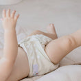 Load image into Gallery viewer, Baby wearing a Reusable Cloth Nappy – Ivory | 2.0 | My Little Gumnut, designed for comfort and everyday movement.
