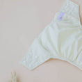 Load image into Gallery viewer, Reusable Cloth Nappy – Ivory | 2.0 | My Little Gumnut folded flat to showcase the neutral ivory design and adjustable fit.