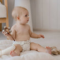 Load image into Gallery viewer, Baby wearing a Reusable Cloth Nappy – Ivory | 2.0 | My Little Gumnut shown sitting to demonstrate comfort and fit.