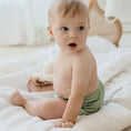 Load image into Gallery viewer, Baby wearing a Reusable Cloth Nappy – Sage | 2.0 | My Little Gumnut shown from behind to demonstrate fit and comfort.