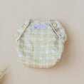 Load image into Gallery viewer, Reusable Swim Nappy in Gingham (Beige) design, perfect for beach days and pool play with comfort and waste reduction.