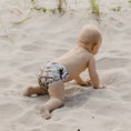 Load image into Gallery viewer, Baby crawling in the sand wearing a Reusable Swim Nappy - Kookaburras from My Little Gumnut.